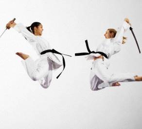 Women fighting with katana swords --- Image by © Ocean/Corbis