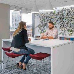 Two people in an office discuss green building design