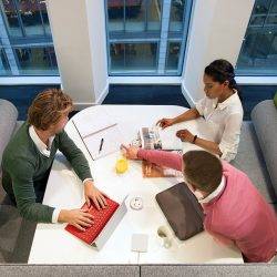 A group of people share ideas around a table