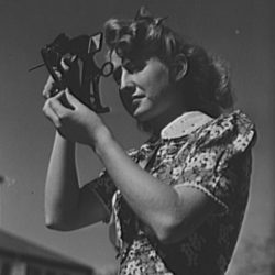 A young woman using a sextant to illustrate the idea of setting targets to create a good workplace culture