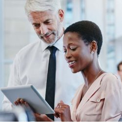 A man and woman discuss a work issue to illustrate importance of wellbeing