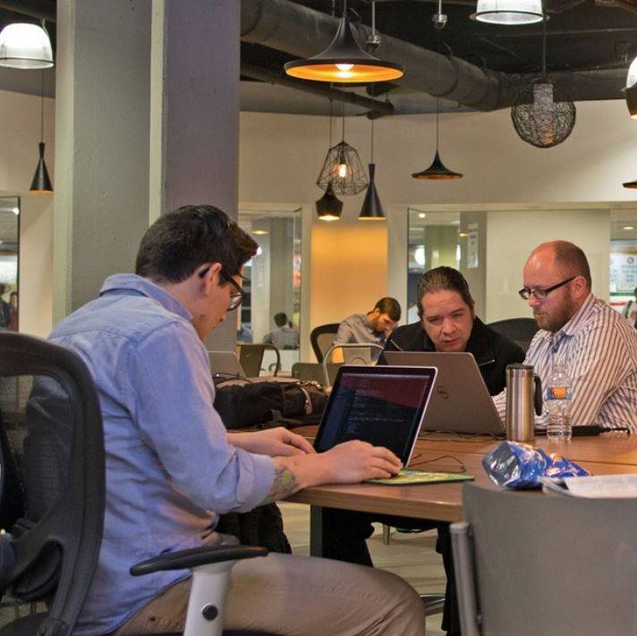 A group of people in a shared flexible working / coworking space