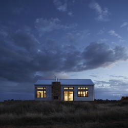 An isolated house in the night poses the question whether people want to heat a home office