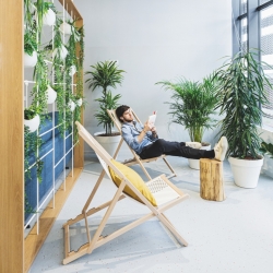 A man relaxing in a green office space to illustrate the circular economy in the commercial property sector