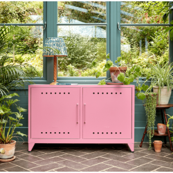 Pink Bisley Fern cabinet in a plant filled room