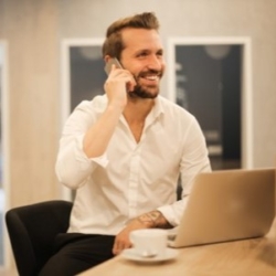 Businessman using enterprise search tool and talking on the phone